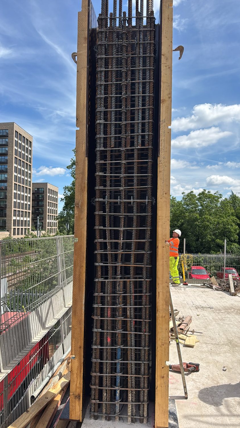 Tall reinforced-concrete wall reinforcement cage in shutter on a city-centre site