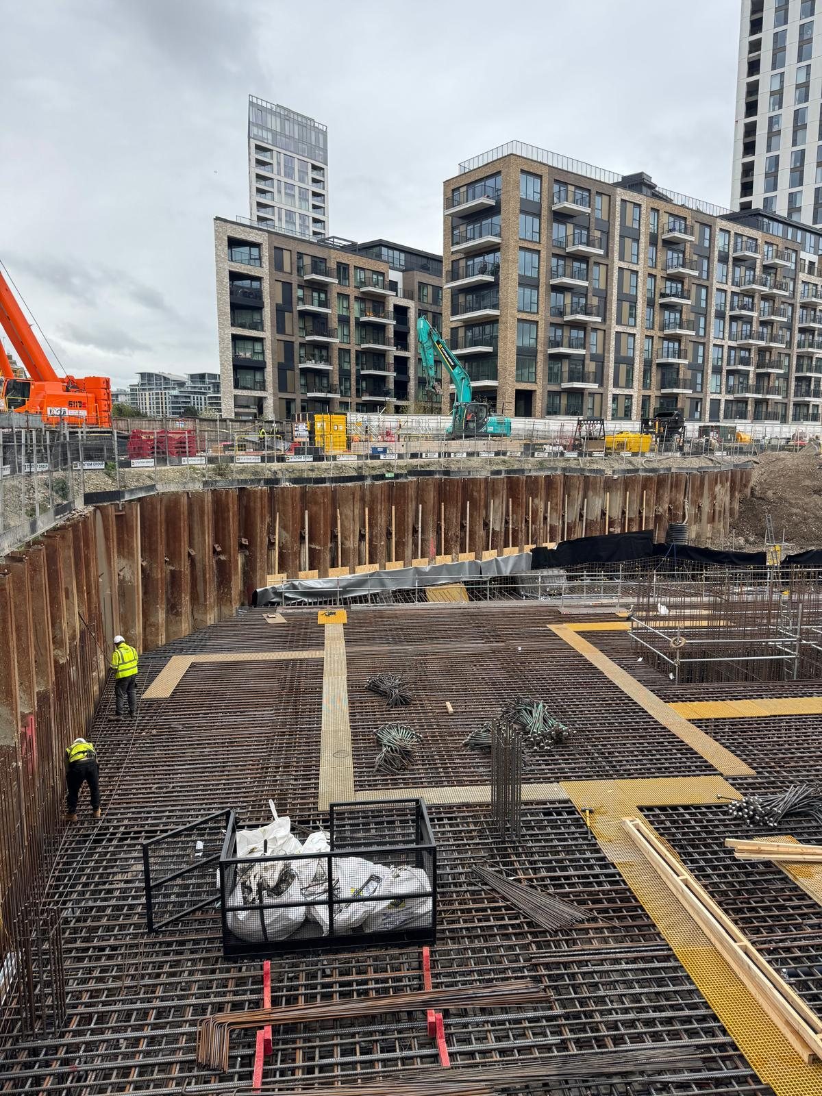 Reinforcement deck with tower blocks under construction behind